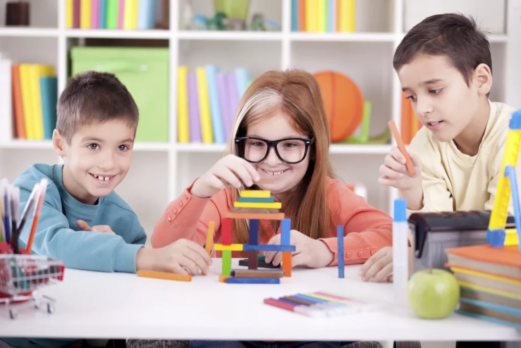 Image of three children with special needs working together in a inclusive education activity