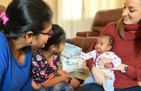 Image of a loving family gathered around their baby, emphasizing the importance of early intervention