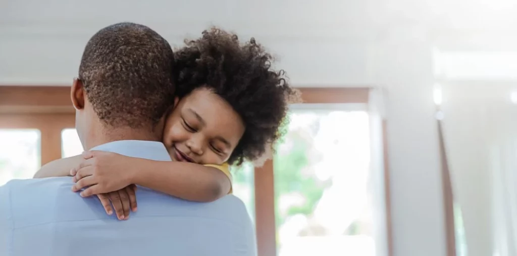 Image of a child embracing their parent with a heartfelt hug, highlighting emotional well-being