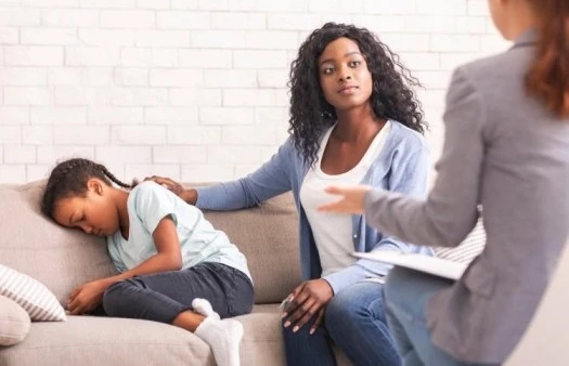 Image of a caring mom offering support and comfort to her child during a therapy session, emphasizing emotional well-being