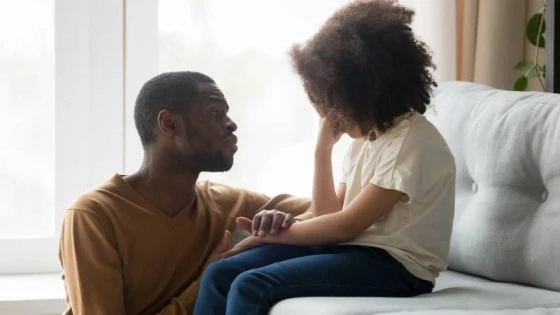 Image of a caring father comforting his little girl, emphasizing emotional well-being