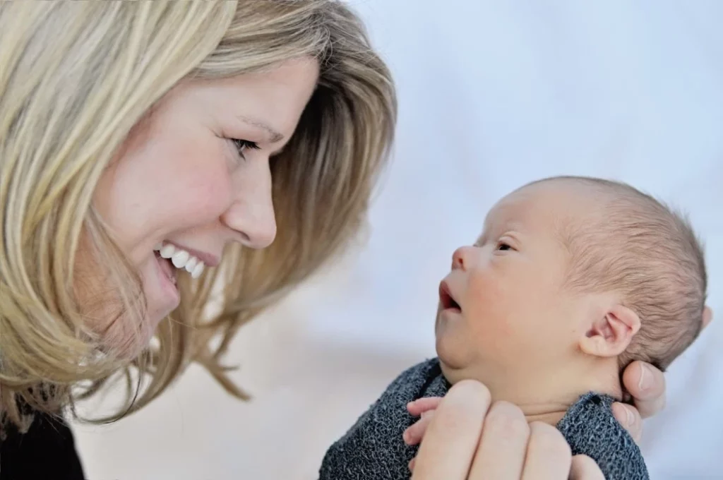 A heartwarming image of a mother tenderly embracing her baby with Down Syndrome, showcasing the powerful bond between them.