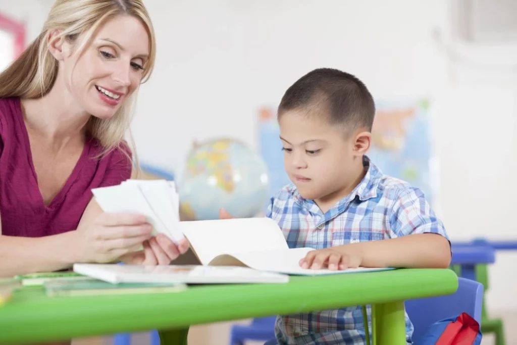 A teacher actively participates in an activity with a student, fostering smooth transitions in the school environment.