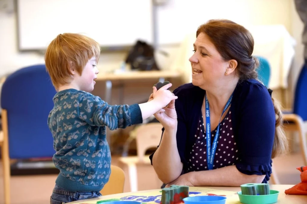 A teacher and child actively participating in speech therapy session